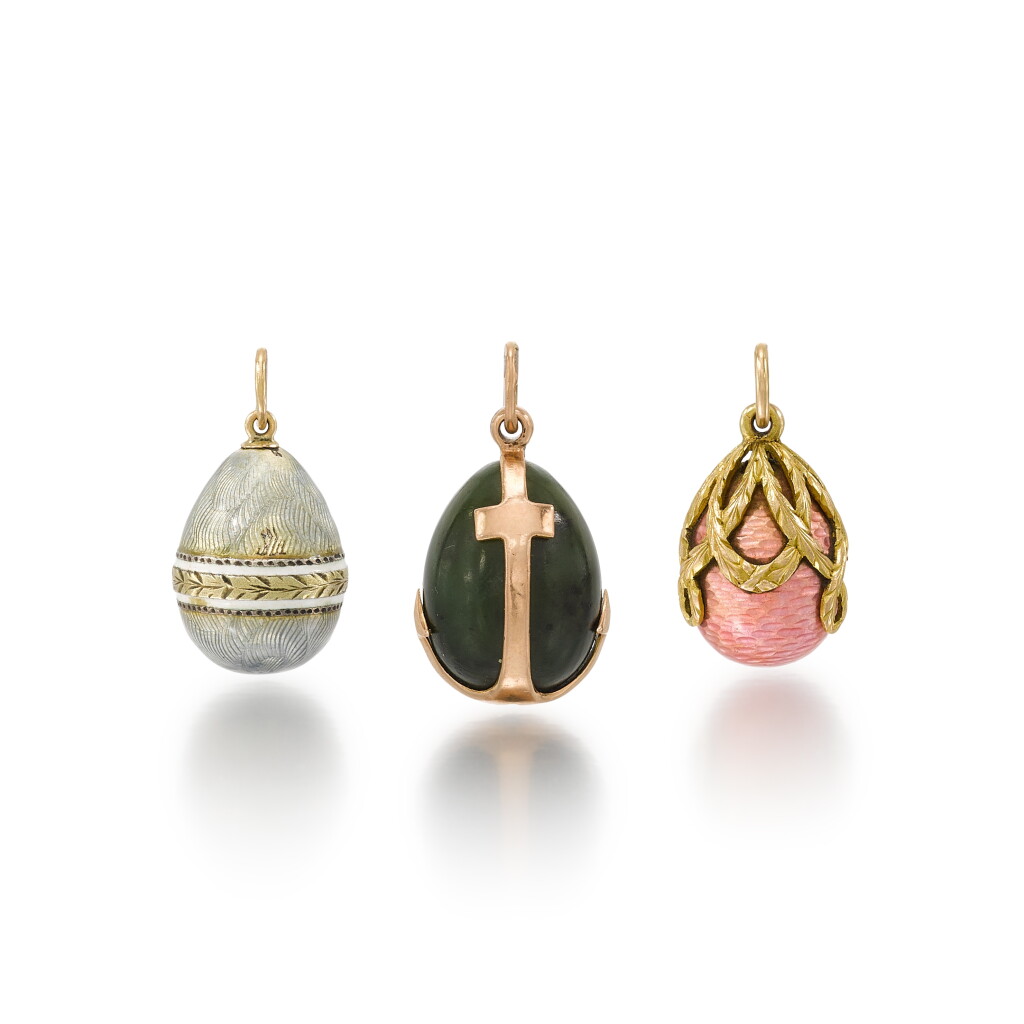 View full screen - View 1 of Lot 1040. A group of three gold egg pendants in the style of Fabergé.