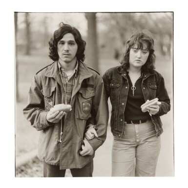 View full screen - View 1 of Lot 19. DIANE ARBUS | A YOUNG MAN AND HIS GIRLFRIEND WITH HOT DOGS IN THE PARK, NYC.