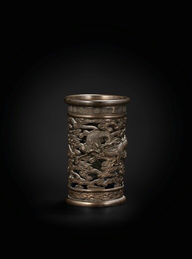 View full screen - View 1 of Lot 227. A bronze reticulated 'dragon' brushpot Qing dynasty, 18th century | 清十八世紀 銅鏤空雲龍紋筆筒.