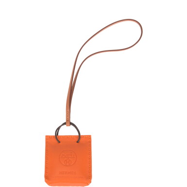 View full screen - View 1 of Lot 144. Hermès Orange Shopping Bag Charm.