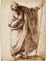 A standing figure of a man wearing a cloak and holding a stick