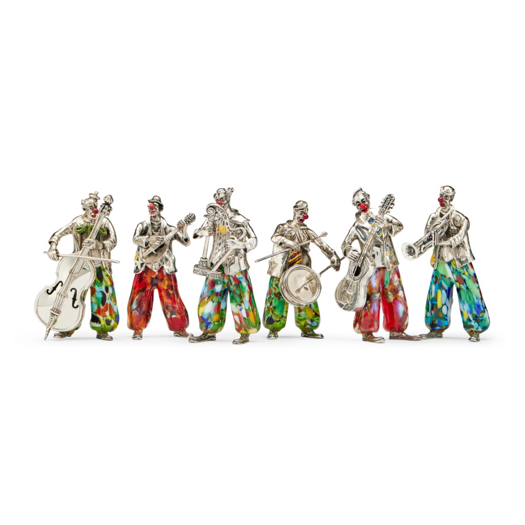 View full screen - View 1 of Lot 117. A Group of Six Italian Silver, Enamel, and Murano Glass Musician Clowns, Designed by Vittorio Angini for Sorini, Arezzo, Late 20th Century.
