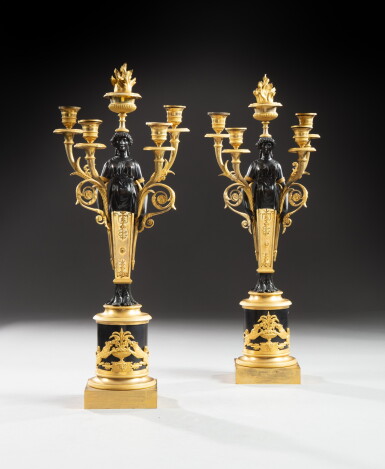 View full screen - View 1 of Lot 54. A pair of patinated and gilt-bronze five-light candelabra, Empire, circa 1810 | Paire de candélabres aux termes antiques à cinq lumières en bronze patiné et doré d'époque Empire, vers 1810.