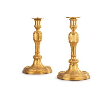 View full screen - View 1 of Lot 205. A pair of gilt-bronze candlesticks, Louis XVI style, second half of 19th century | Paire de flambeaux en bronze doré de style Louis XVI, seconde moitié du XIXe siècle.