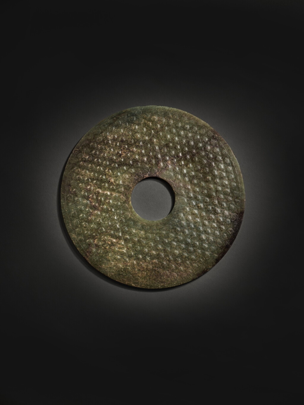View full screen - View 1 of Lot 245. An archaic green jade disc (Bi), Han dynasty | 漢 玉蒲紋璧.