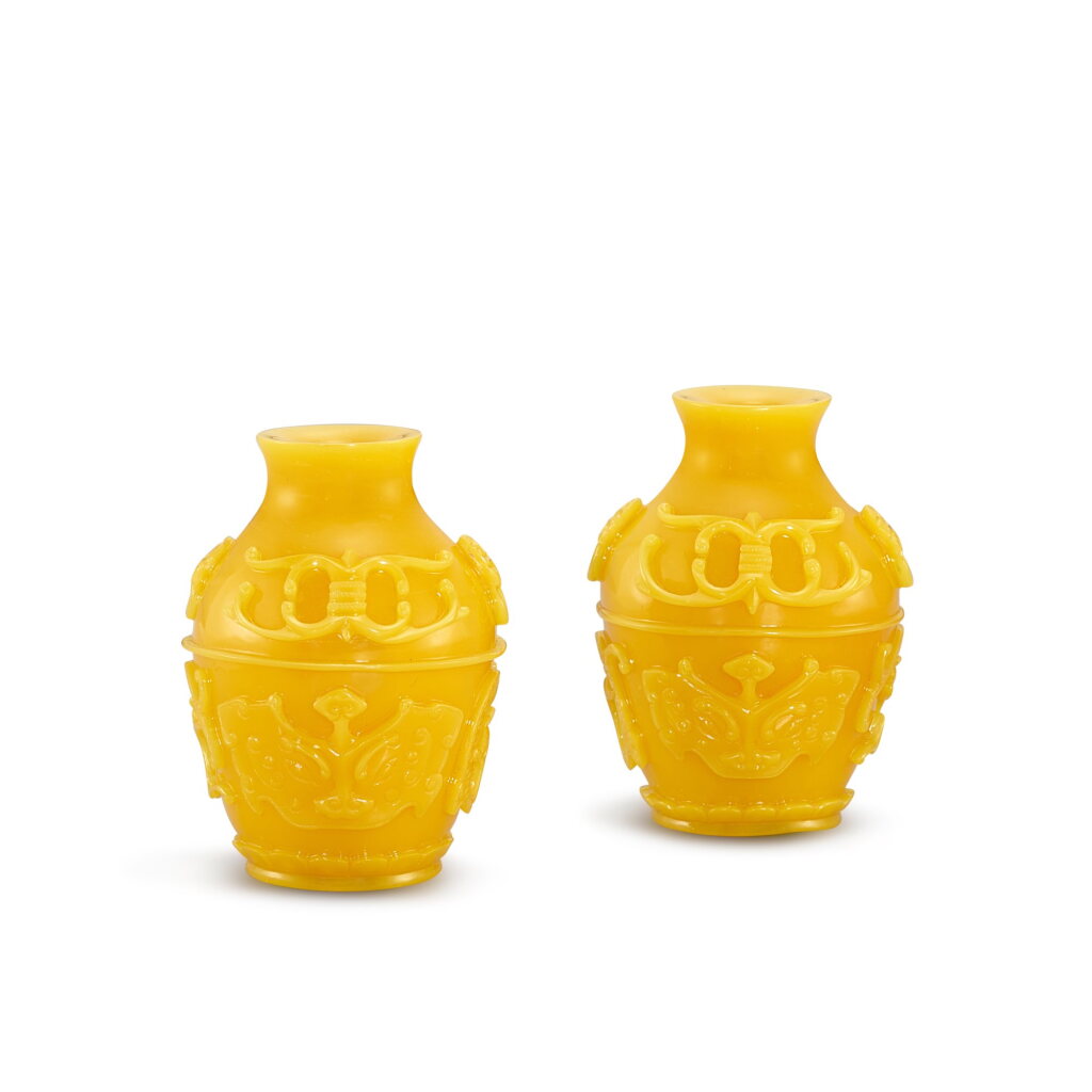 View full screen - View 1 of Lot 558. A pair of carved archaistic opaque yellow glass miniature jars, Qing dynasty, 18th - 19th century 清十八至十九世紀 黃料饕餮龍鳳紋小瓶一對 《乾隆年製》款.