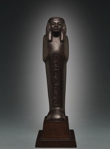 View full screen - View 1 of Lot 66. AN EGYPTIAN BROWN SERPENTINE USHABTI OF NEDJEM-IB, LATE 12TH/13TH DYNASTY, CIRCA 1800-1640 B.C..