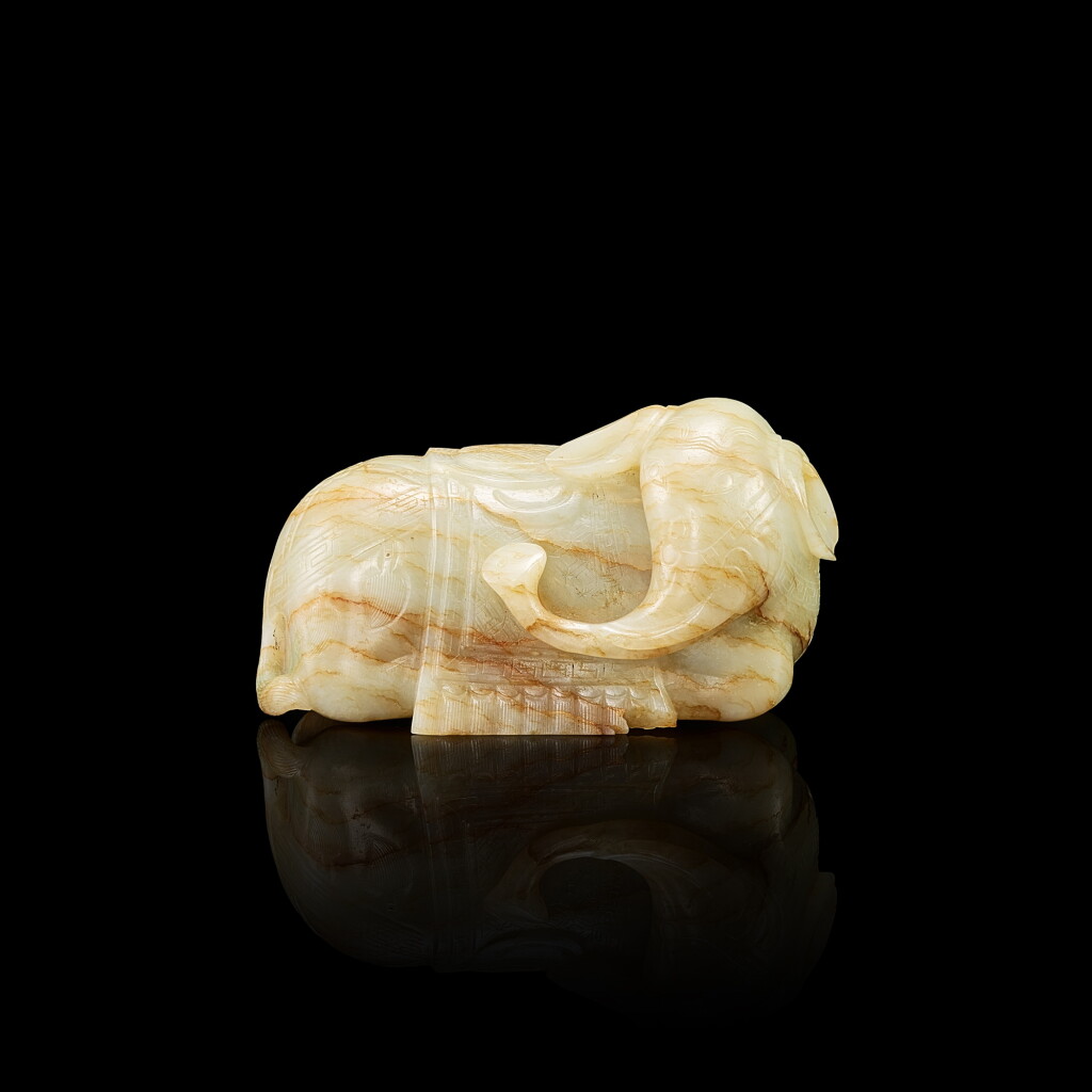 View full screen - View 1 of Lot 3017. A white jade recumbent elephant, 17th century 十七世紀 白玉臥象.