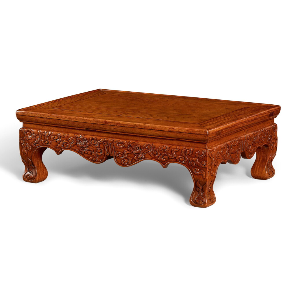 View full screen - View 1 of Lot 23. A HUANGHUALI 'CRANE' LOW TABLE, KANGJI MING DYNASTY, 17TH CENTURY | 明十七世紀 黃花梨雕雲鶴紋炕几.