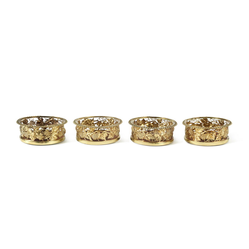 View full screen - View 1 of Lot 491. A Set of Four George IV Silver-Gilt Wine Coasters, Craddock & Reid, London, 1821.