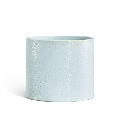 View full screen - View 1 of Lot 317. A carved white-glazed 'lotus' brushpot, Qing dynasty, Kangxi period 清康熙 白釉刻纏枝蓮紋筆筒 《成化年製》仿款.