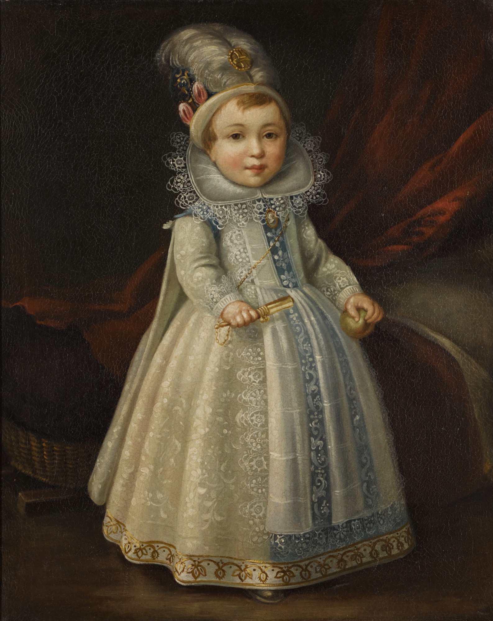 MANNER OF CORNELIS DE VOS | Portrait of a young boy, standing full-length, wearing a white dress with a lace collar and feathered hat, holding a rattle and an apple