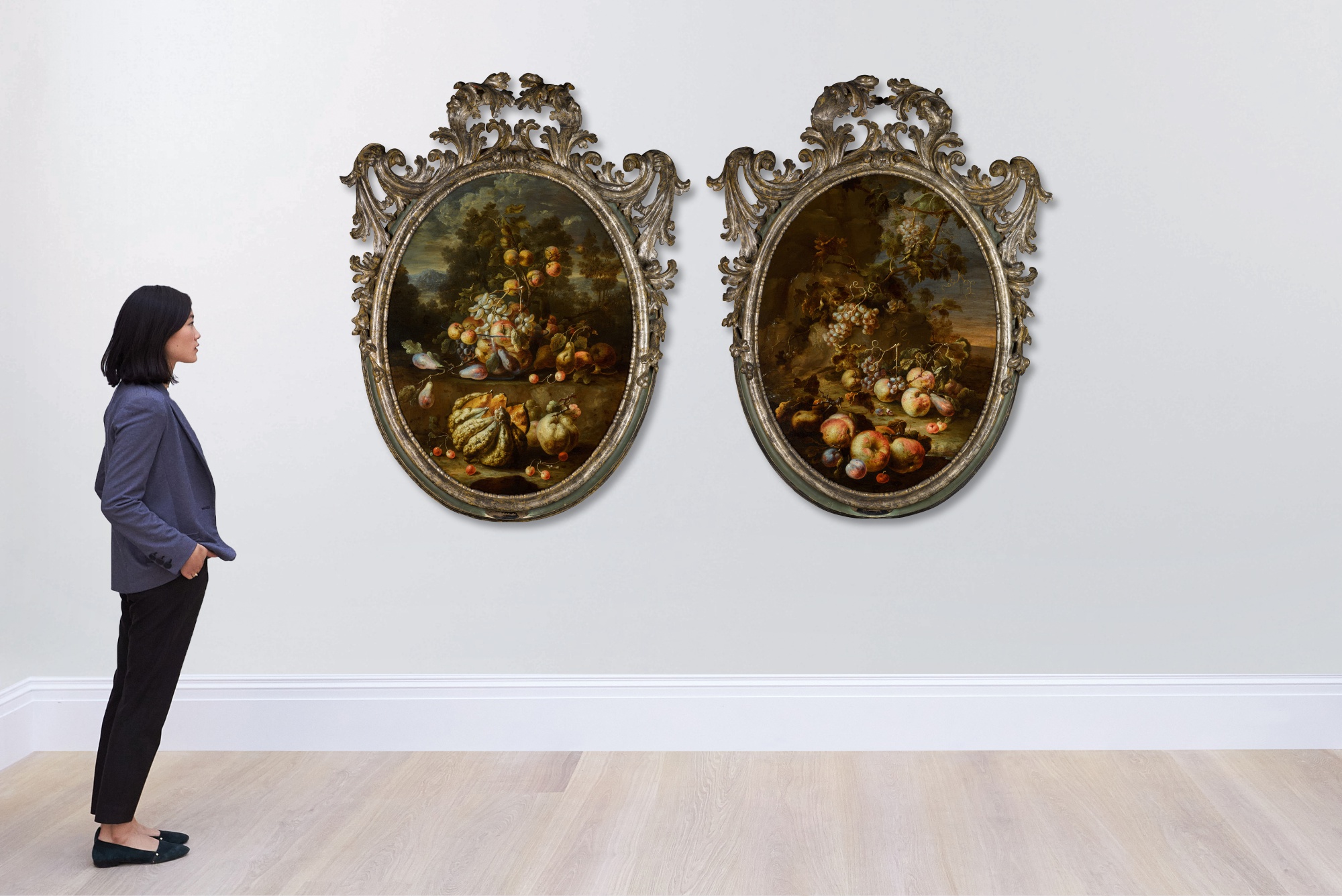 A pair of still lifes with apples, peaches, pears, plums, cherries