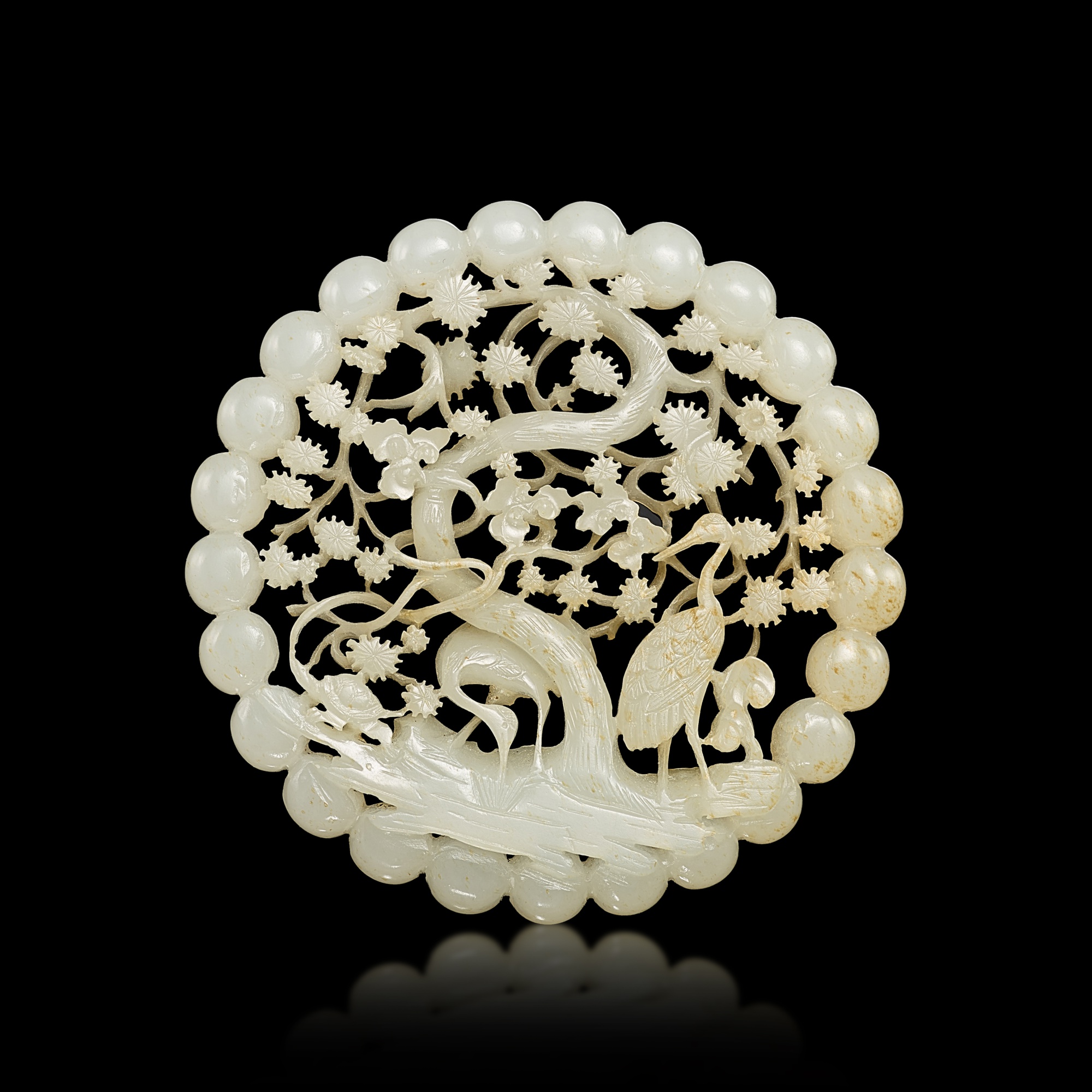 A reticulated white jade 'pine and crane' plaque, Qing dynasty, 18th