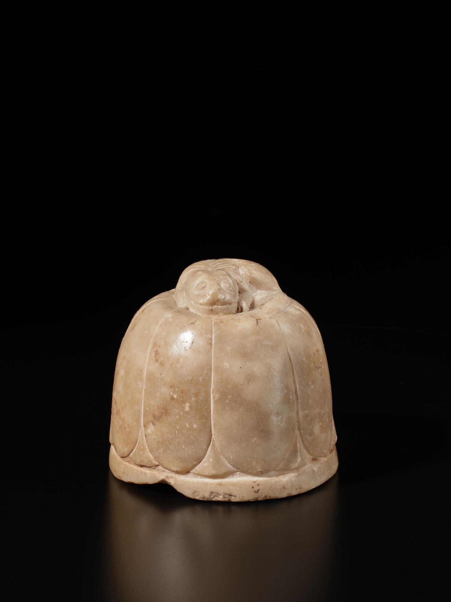A white marble 'lion and lotus' scroll weight, Tang dynasty Dharma